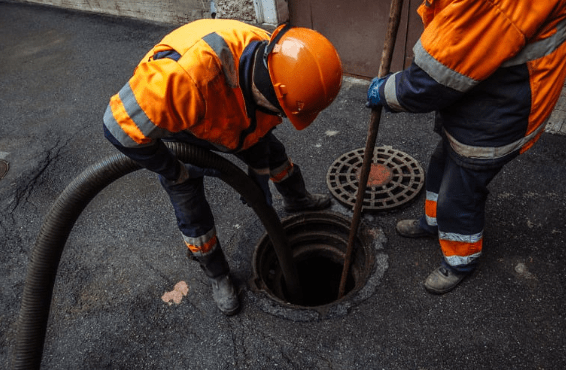 techs cleaning sewer line